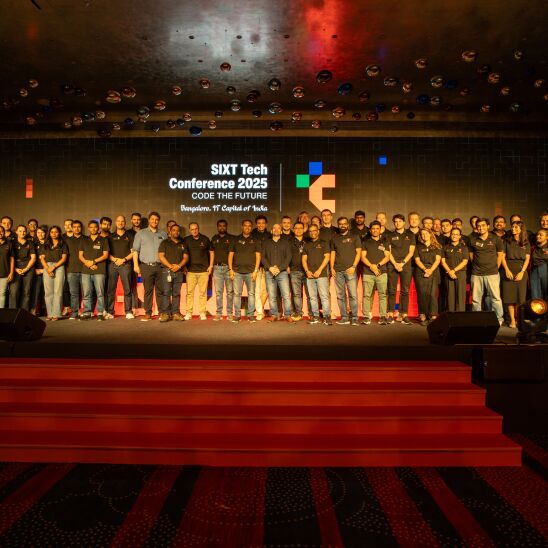 A big group of people from SIXT TECH standing on the stage of SIXT TECH conference 2025