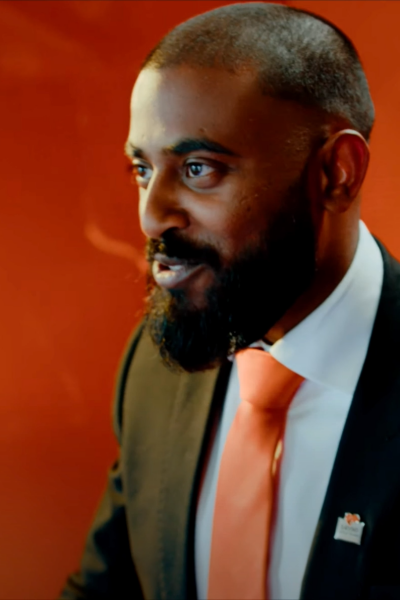 A Rental Sales Agent in his uniform talking.