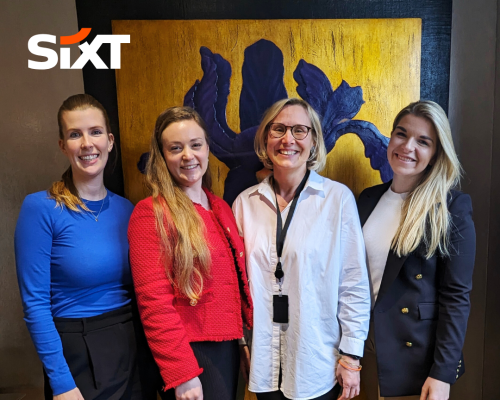 Four women smiling directly at the camera.